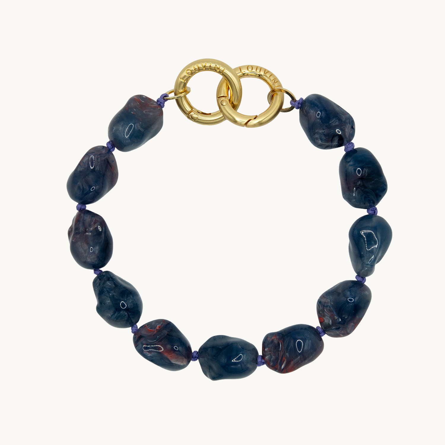 Petite chaîne bracelet de telephone avec pierres bleues en résine et anneaux dorés