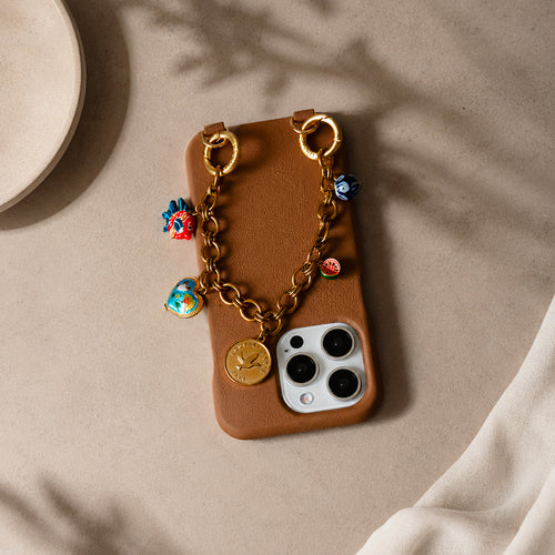 coque iphone en cuir beige camel et bracelet de téléphone chaine dorée à charms